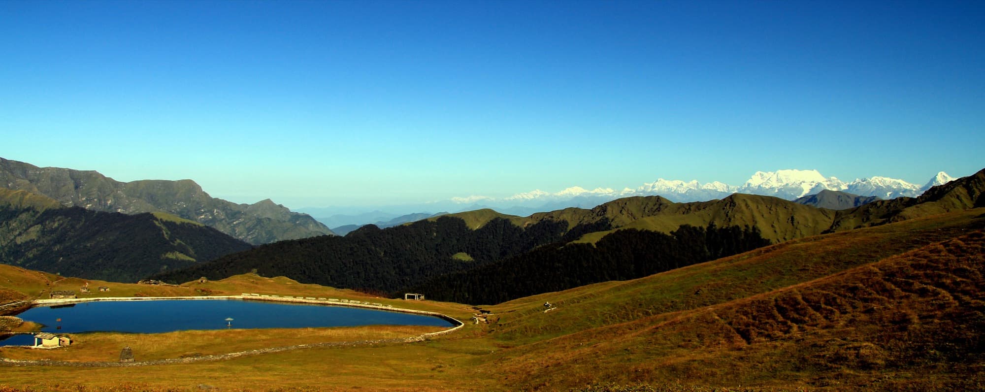 Bedni Kund on the autumn meadow, with snow peaks on the horizon