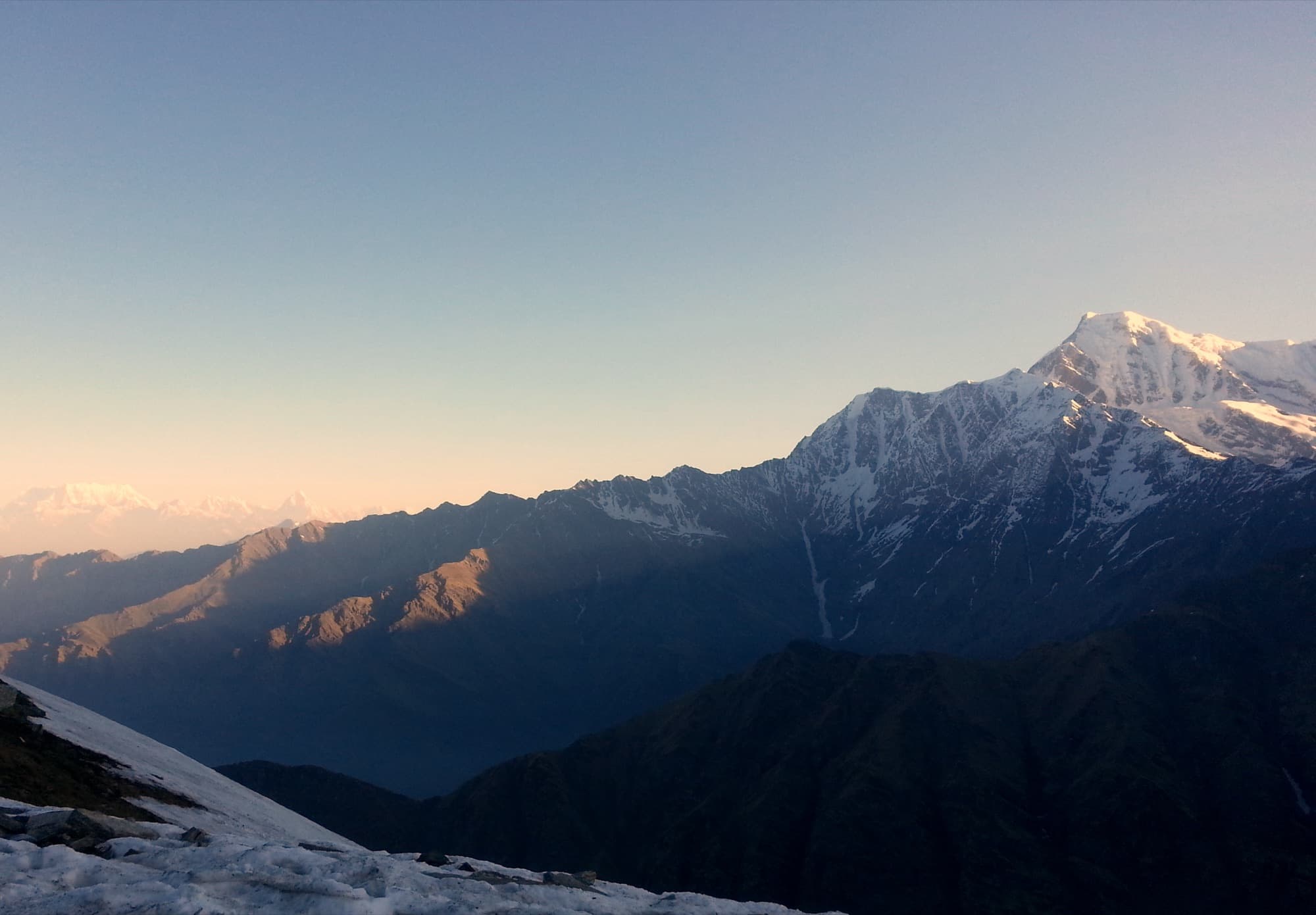 First light on a snow peak from the upper Roopkund trail
