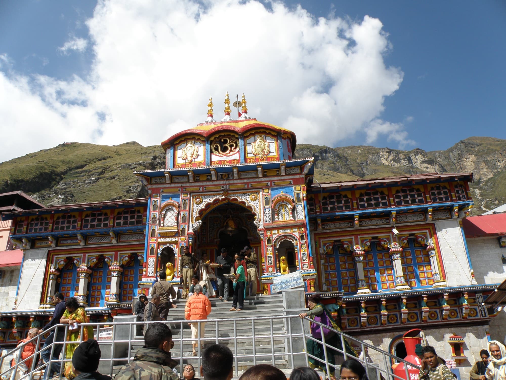 The brightly painted facade of Badrinath temple under a blue sky