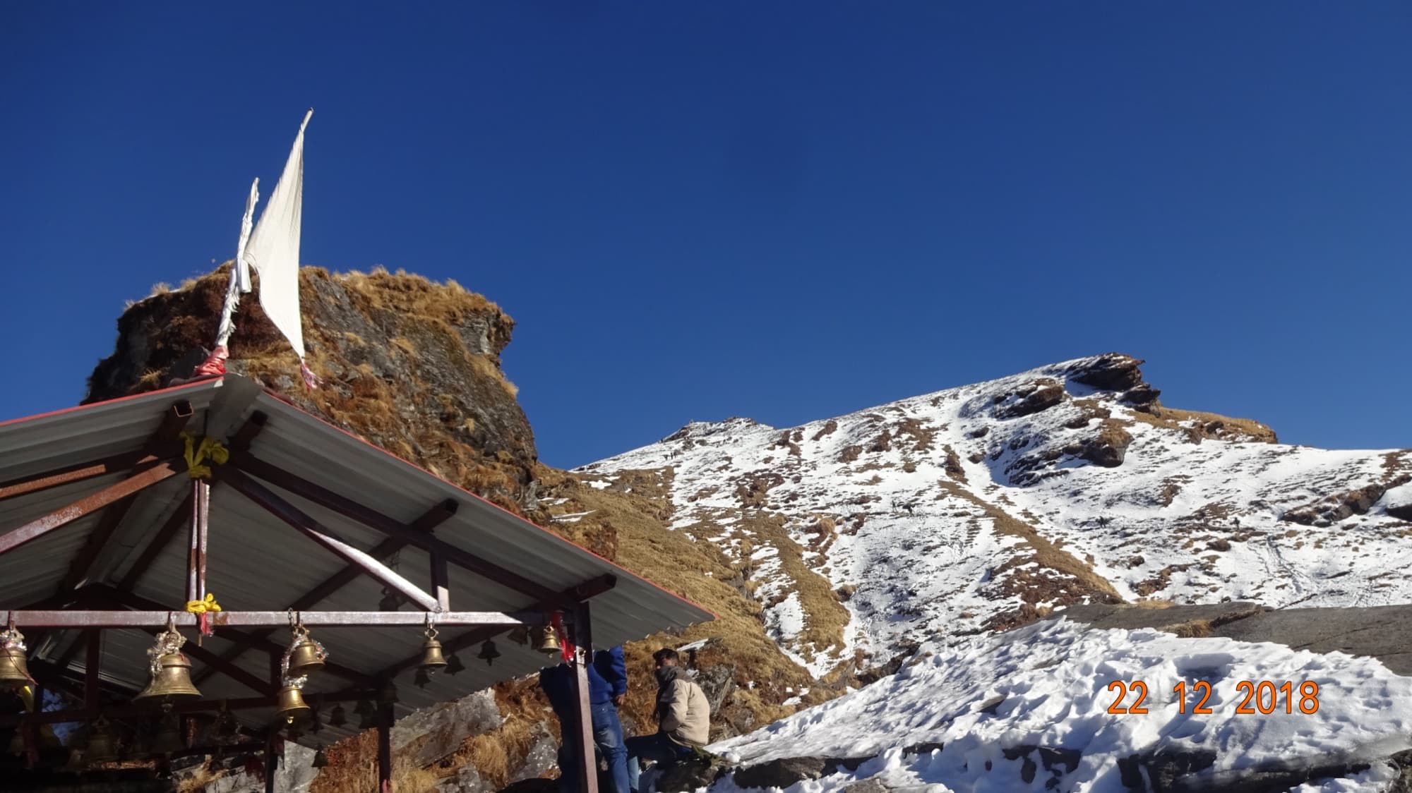 Bells at a shrine near Tungnath, with Chandrashila summit behind
