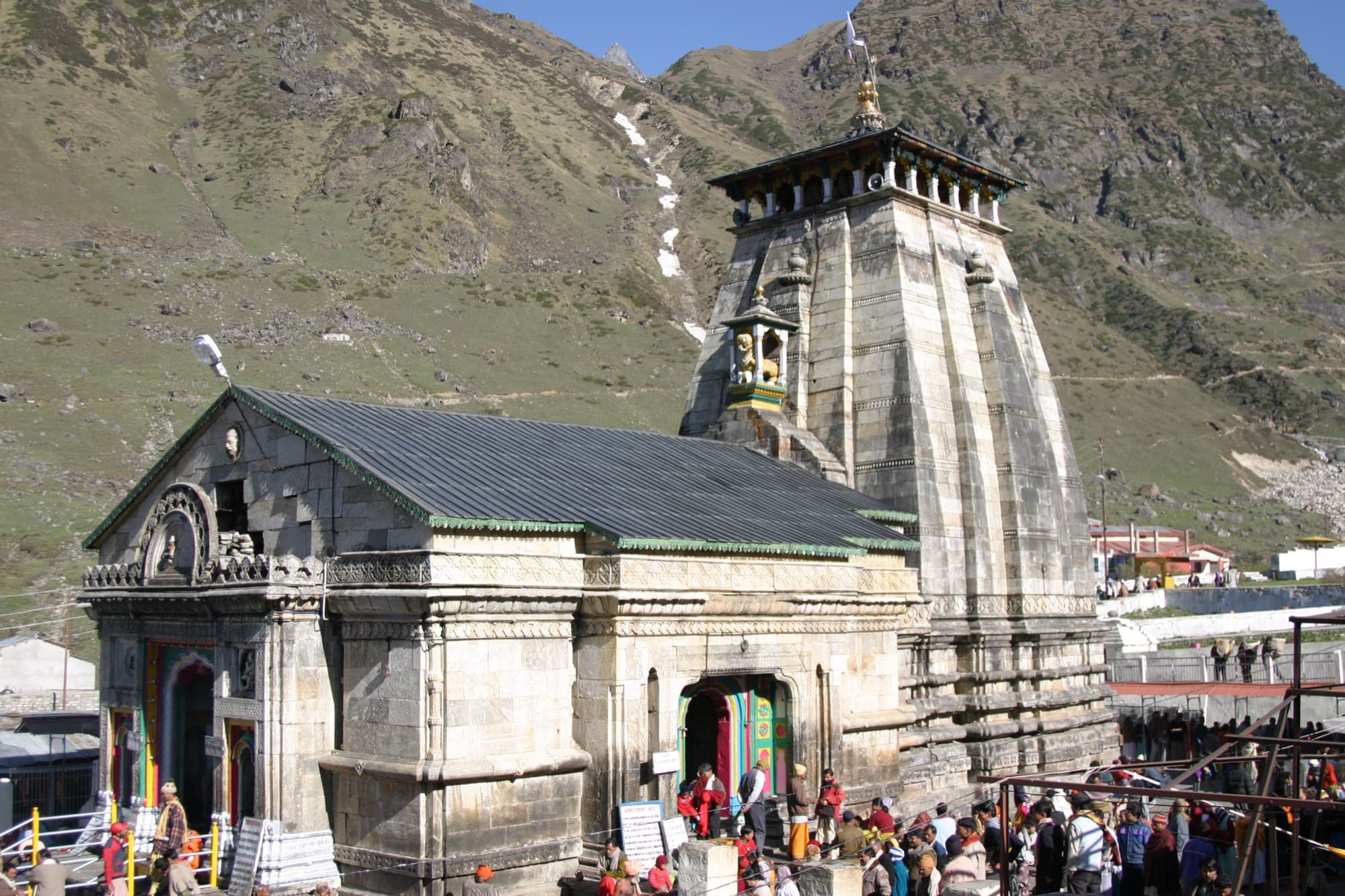 Kedarnath temple’s stone spire with pilgrims at the entrance